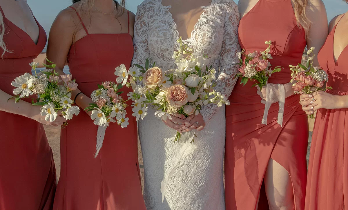 Bridesmaids holding bouquets at a beach wedding San Diego