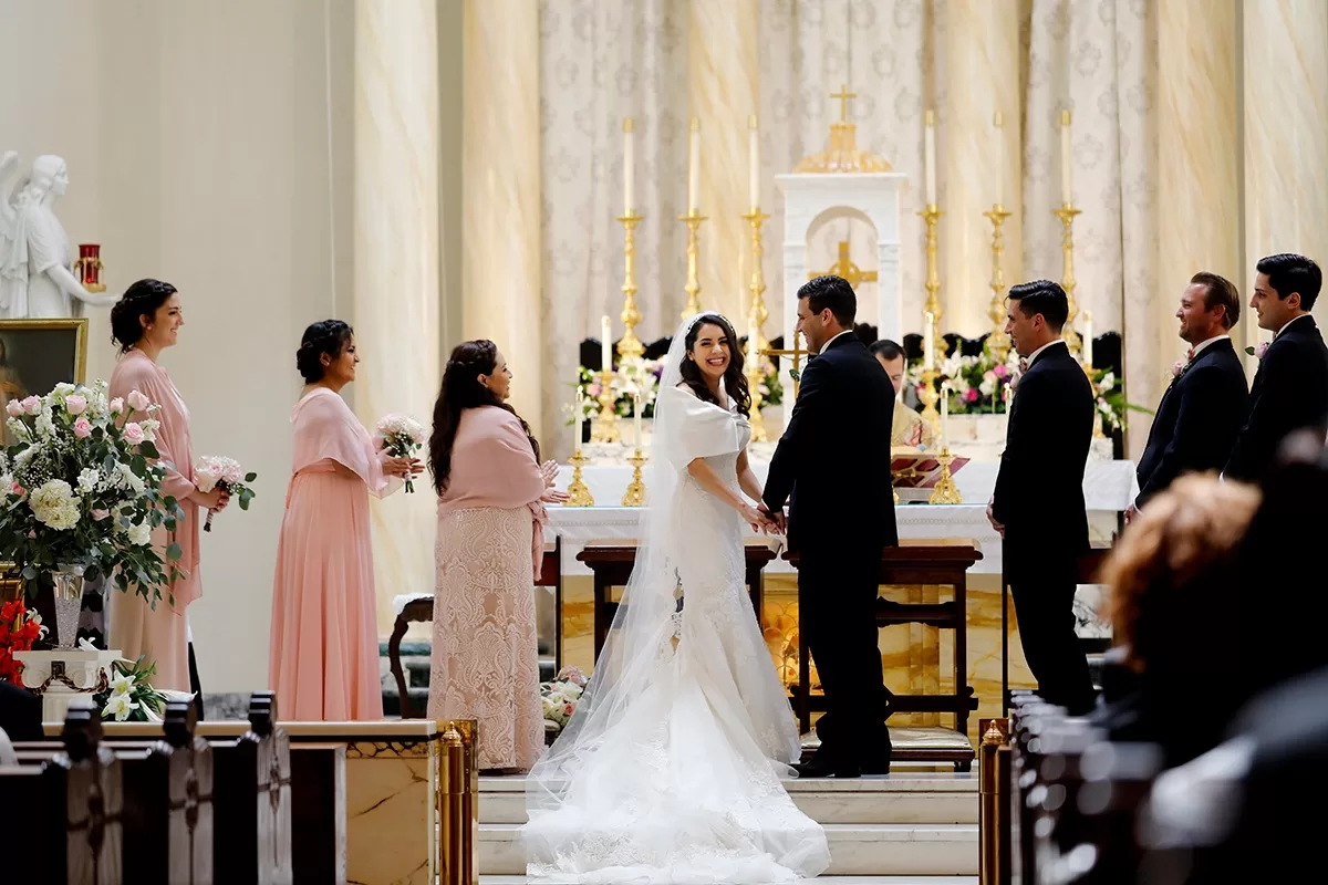 Church wedding candid photo of bride and groom with bridesmaids and groomsmen